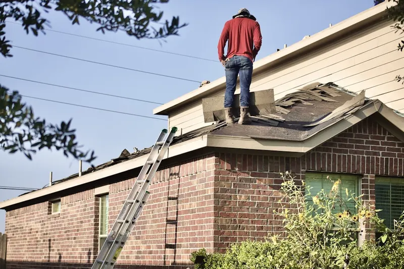 Professional roofer working on a residential roof in La Quinta
